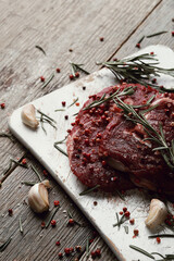 Raw fresh red meat with rosemary and spices