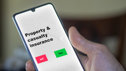 Property and casualty insurance, an investor's analyzing the stocks on screen. A phone shows the ETF's prices casualty and property insurance.