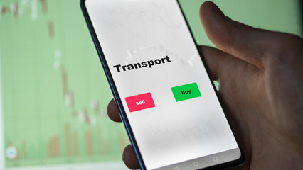 An investor's analyzing the stocks on screen. A phone shows the ETF's prices transport