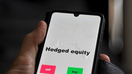 An investor's analyzing the stocks on screen. A phone shows the ETF's prices hedged equity, english text.