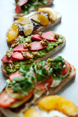 Various tasty fresh Bruschetta (sandwiches) with cherry tomatoes, mozzarella cheese and herbs on a white background. 