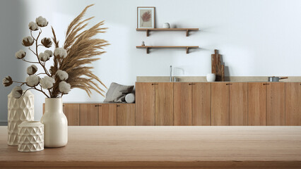 Wooden table, desk or shelf close up with ceramic vases with cotton flowers over japandi kitchen, minimalist style interior design concept