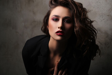Fototapeta premium A photo of a young beautiful woman model in black posing for camera