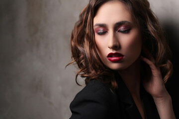 A photo of a young beautiful woman model in black posing for camera