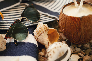 Delicious refreshing coconut drink with beach accessories on the shells