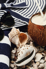Delicious refreshing coconut drink with beach accessories on the shells