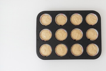 The process of making homemade cupcakes, top view. fill the form with dough. Step four