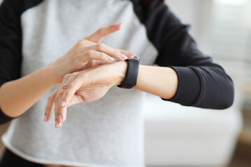 Women hands checking her smart watch