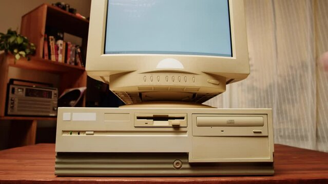 Using diskette for old computer. Music recorder, playing retro computer games. Vintage device for office, obsolete technology. 