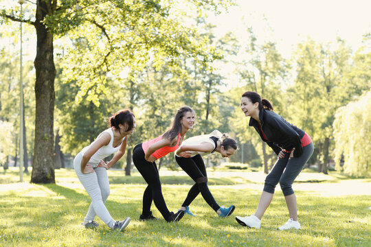Group of people doing flexibility exercises at the park