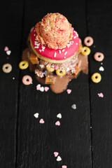 Top view of yummy sweet donuts with ice cream on a wooden black surface