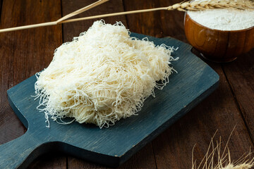 Kataifi dough on a wooden board, not cooked dough, wooden table.