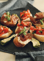 Delicious snacks in the form of mini sandwiches with meat and vegetables for the party