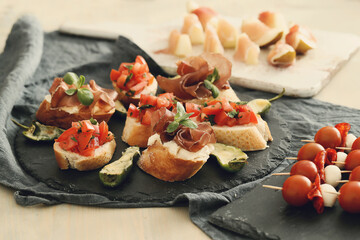 Delicious snacks in the form of mini sandwiches with meat and vegetables for the party