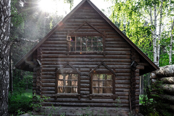 An old log house at dawn.