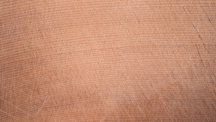 Fototapeta premium top view of brown hardwood cutting board for kitchen accessories. There are scratches from use. Natural Wood texture Background, Surface of teak, Wooden Desk Texture.