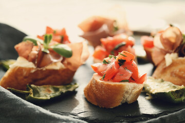 Delicious snacks in the form of mini sandwiches with meat and vegetables for the party