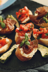Delicious snacks in the form of mini sandwiches with meat and vegetables for the party