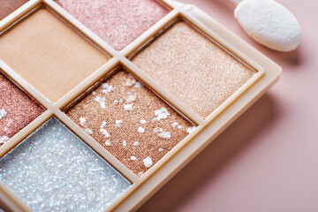 Eyeshadow colorful shades palette in beige tones close-up. Beauty abstract background