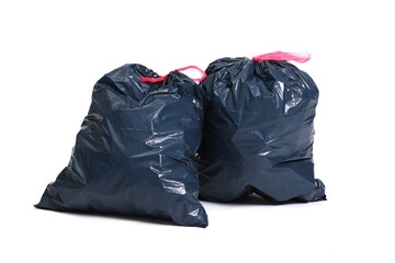 Two big black plastic bags for trash waste placed on a white background