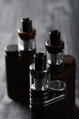 Close view of vaping device on a wooden dark background