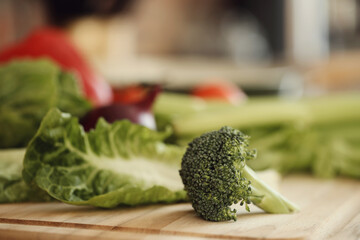 Different, fresh vegetables consisting of broccoli, tomatoes, celery, potatoes, onions and peppers