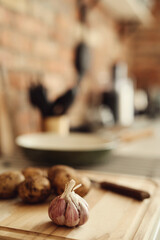 Fresh, sweet potatoes with garlic on the kitchen table