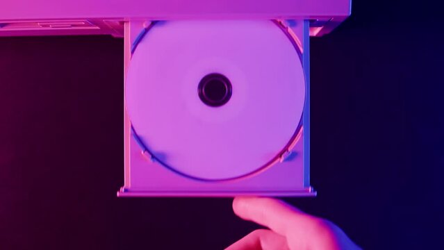 Using CD circle disk close-up. Old dvd player, disc drive top view. Music recorder, playing retro computer games. 