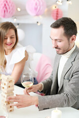 Friends have fun playing games and drinking champagne at the party