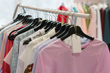 Close view photo of clothes on a hanger in a modern boutique store
