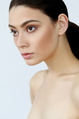 Close-up portrait of a young,beautiful,naked woman looking away on a white background