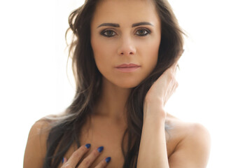 Photo of a beautiful,brunette woman with blue manicure posing and looking into the camera