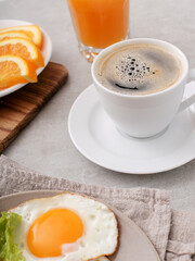 Fototapeta premium Morning breakfast with fried eggs,orange juice and a cup of coffee on a marble background