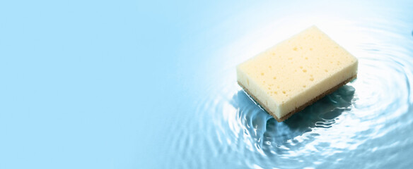 The sponge falls into the water.