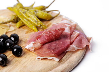 Delicious snacks isolated on a wooden cutting board.