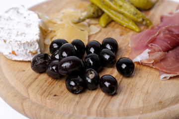 Delicious snacks isolated on a wooden cutting board.