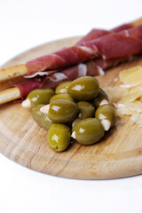 Side view of delicious snacks isolated on a wooden cutting board.