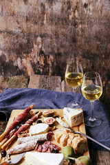 Delicious food with two glasses of champagne on a wooden background