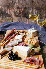 Delicious food with two glasses of champagne on a wooden background
