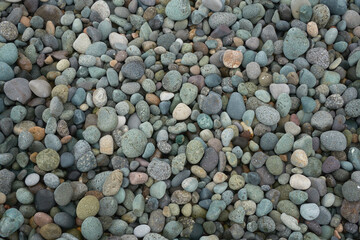 Small pebble rock background texture at the beach.