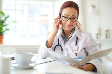 Female doctor having a phone call on medical office