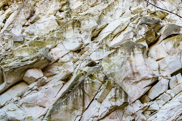 Texture cracked rock formation rock in the wild. Background with copy space