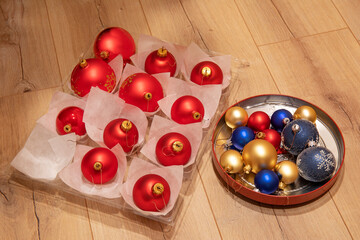 Christmas baubles in box on a wooden floor