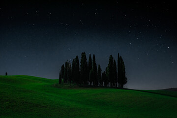  Val d'Orcia, Italy, 15 April 2022:  Starry sky over the cypress island