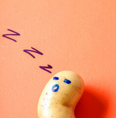 Funny image of human emotions drawing on potato on a red background.