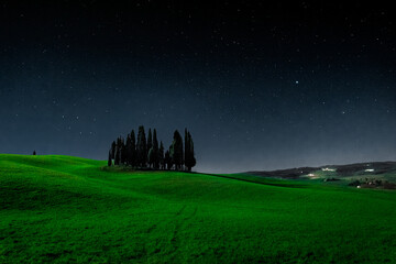 Val d'Orcia, Italy, 15 April 2022:  Starry sky over the cypress island