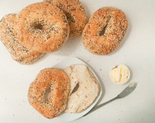 bagels with sesame seeds and chia, butter on a plate, kitchen top 
