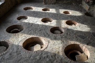 Production traditional Georgian wine in underground clay vessels called qvevri. Underground fermentation 
