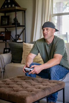 Marine veteran at home with family playing video games