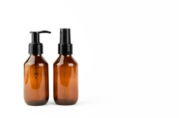 Cosmetic bottles with dispensers on a white background. SPA products